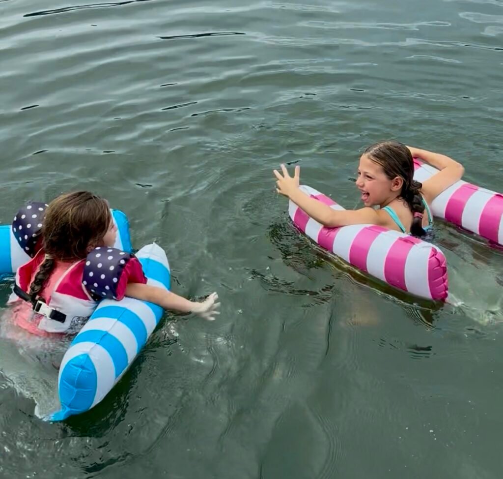 Girls using the 4-in-1  Pool Hammock to float in the lake