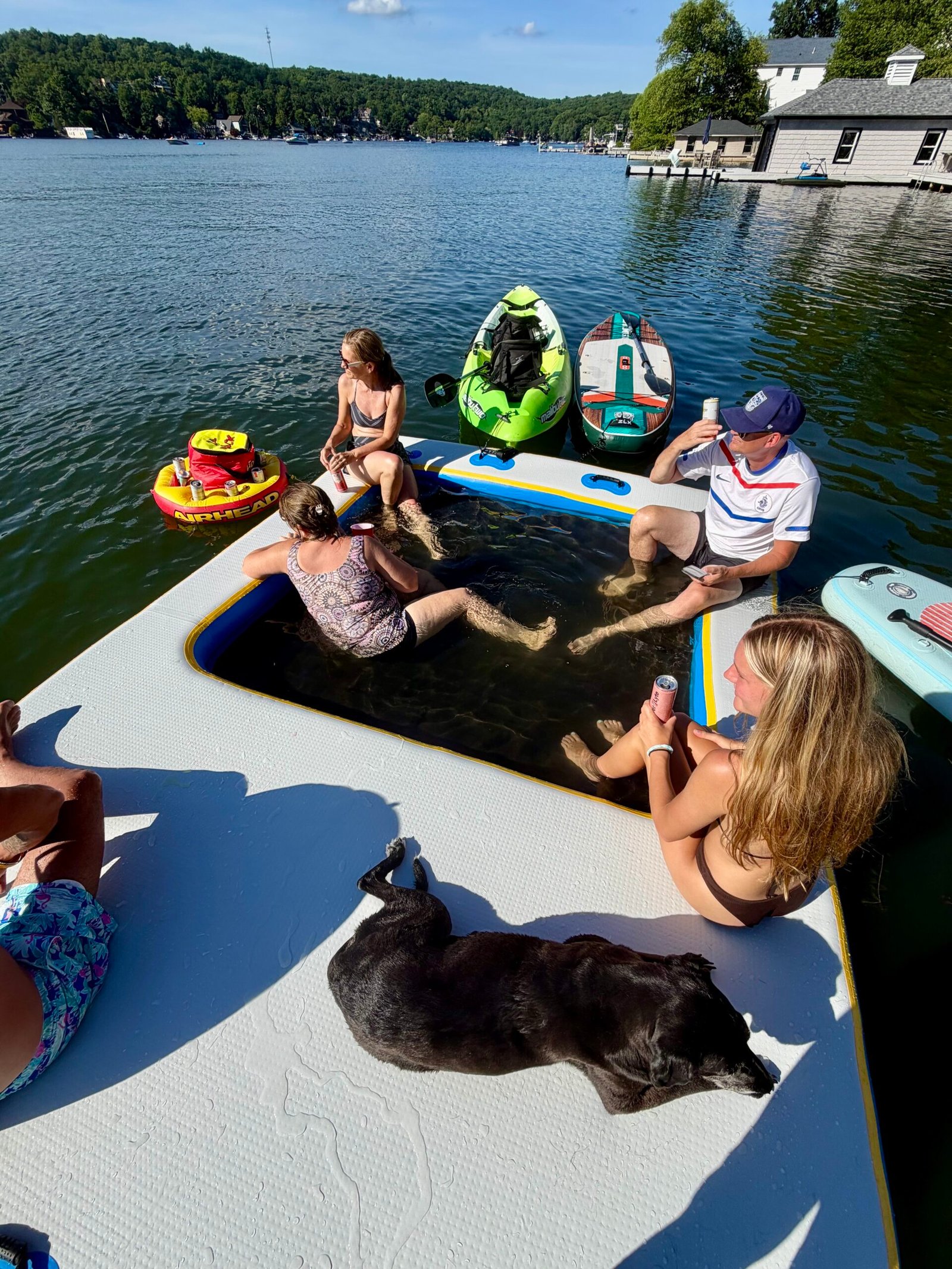 Family hanging on the inflatable dock on lake.