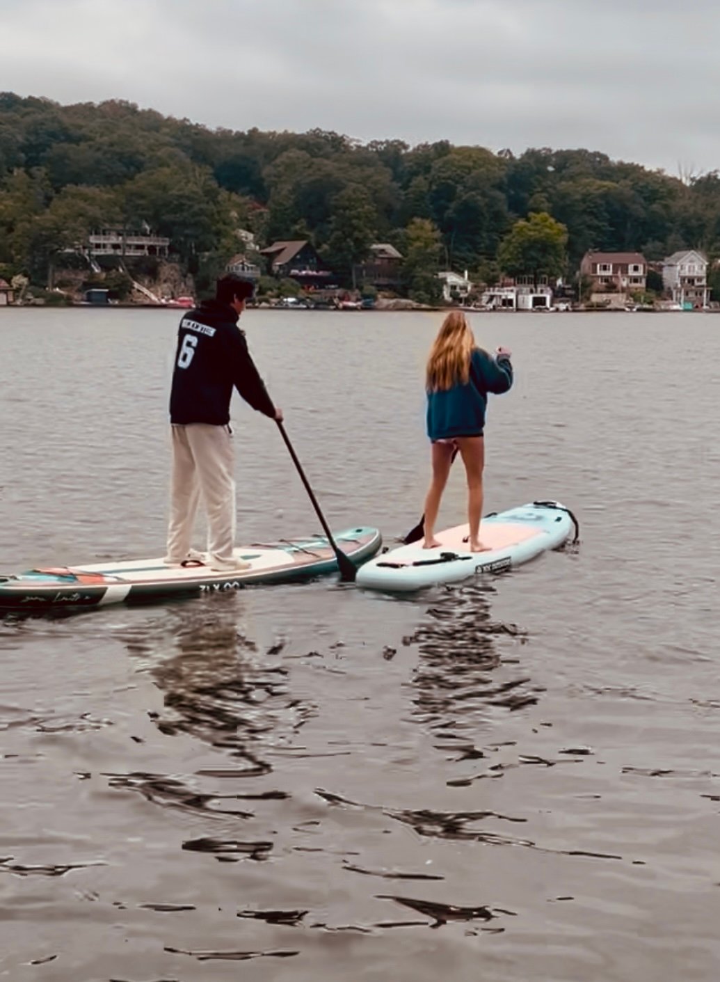 Setting of on their paddle boards to explore the lake.
